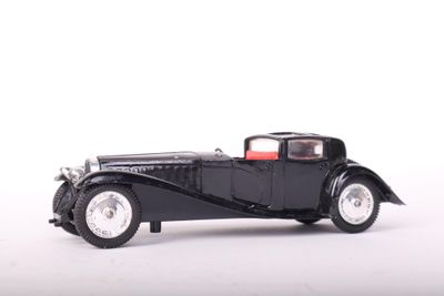 a black model of a car on a white surface