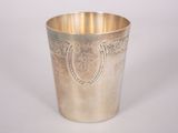 a silver cup sitting on a white surface