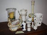 many different vases on a table with a candle on it