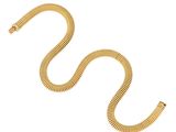 a gold snake bracelet on a white background