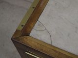 a close up of a marble top table with a drawer