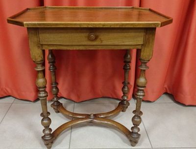 an old wooden table with a mirror on top of it