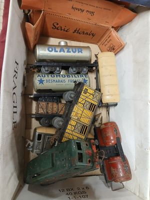 a box full of toy trains and other toy vehicles