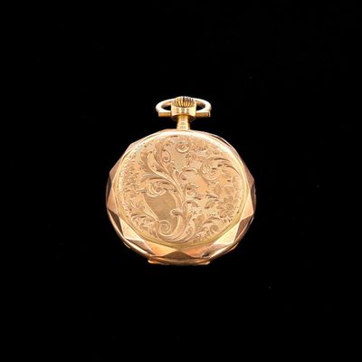an image of a gold pocket watch on a black background