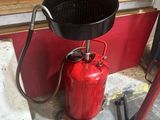 un extincteur posé sur un support à côté d'une borne d'incendie