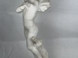 a statue of a little boy holding a flower in his hand