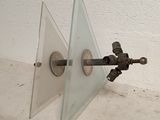 an image of a glass and metal object on a wall