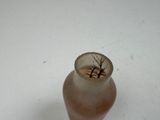a small glass vase with a tree inside of it