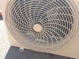 a white air conditioner sitting on the floor