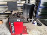 an image of a tire changer in a garage