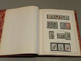 an open book with stamps on it sitting on a table