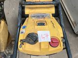 a yellow lawn mower that is sitting on the ground