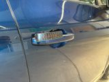 a close up of a car door handle with a sticker on it