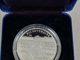 a close up of a silver coin in a blue box