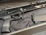 a gun that is in a box on a bed