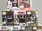 a pile of batman pop vinyl figures on a table