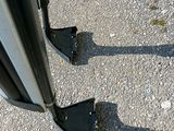 two pieces of metal on the side of the road