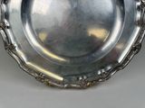 a silver plate that is sitting on a table