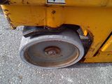 a close up of a wheel on a yellow machine