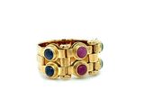 a close up of a gold ring with multi colored stones
