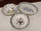 three plates with different designs on them sitting on a table