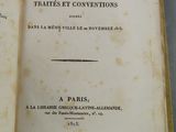 un livre ouvert, dont le titre est visible, posé sur une table