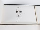 someone is drawing a portrait of a man on a piece of paper