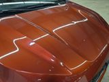 a close up of the hood of a red car