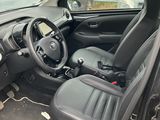 the interior of a car with the door open and the driver ' s seat up