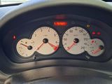 a close up of a car dashboard with various gauges