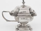 une théière ancienne en argent surmontée d'une horloge