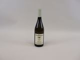 the bottle of wine is sitting on the table ready to be eaten