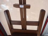 a wooden easer with a sign on it in front of a door
