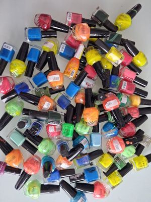 a pile of colorful nail polish bottles on a table