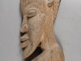pair of carved wooden african head sculptures on a white background