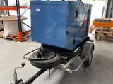 a trailer with a blue compressor on it in a warehouse