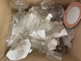 a box full of empty wine glasses and plates
