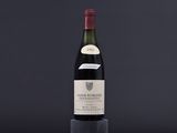 a bottle of wine sitting on top of a wooden table