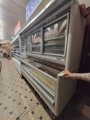 a man that is standing in front of a refrigerator