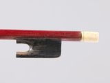 a wooden key with a red handle attached to it