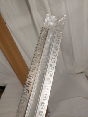 a metal ruler that is sitting on top of a piece of plastic
