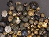 a pile of buttons and other items on a table