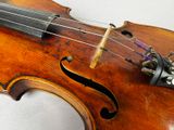a close up of a violin on a white surface
