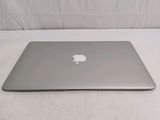 an apple macbook air laptop computer sitting on a white surface
