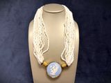 a necklace with a picture on it on a mannequin