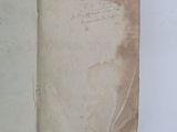 an open book with writing on it sitting on top of a white table