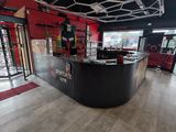 an image of a gym with a bar and a treading machine
