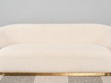 a white couch sitting on top of a checkered floor next to a wall