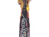 a paint brush with some writing on it on a white surface