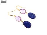 a pair of earrings with blue and purple stones on them